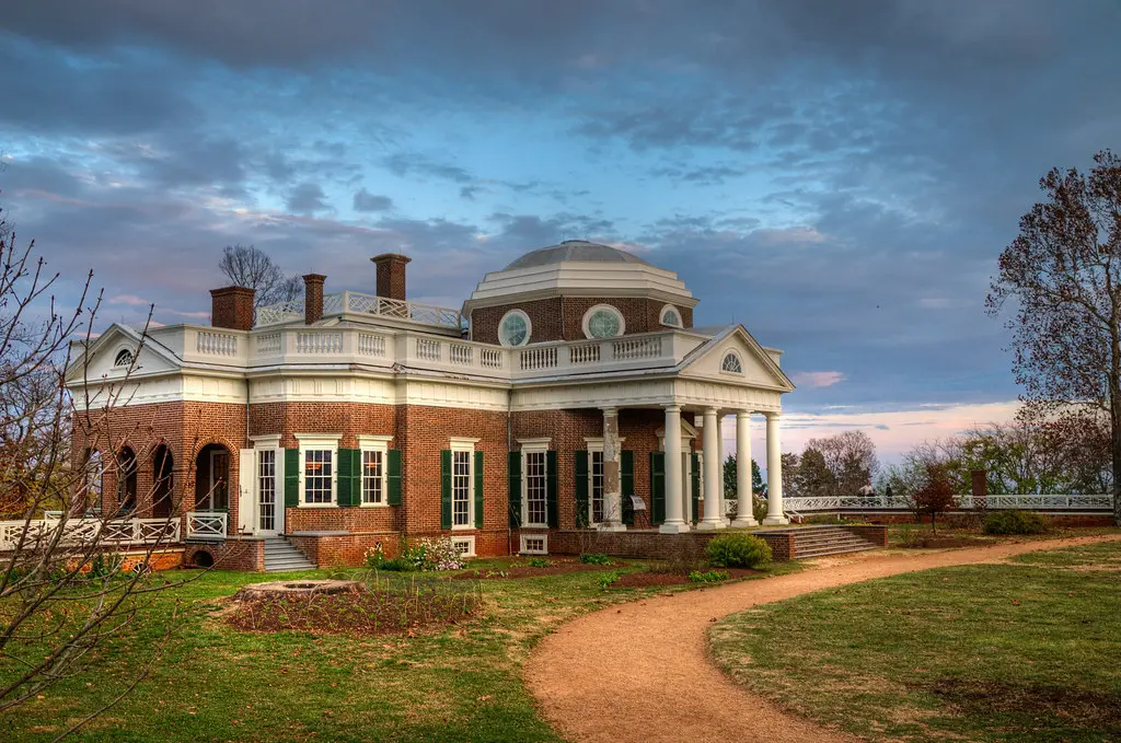 3. Large brick house facade showcasing a striking dome structure above.